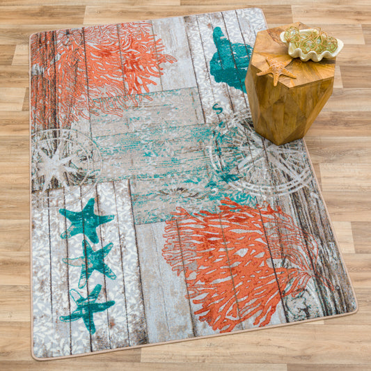 Coastal-themed area rug featuring serene aqua and blue hues on rustic wood plank motifs.