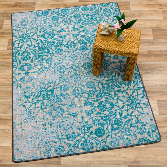 Area rug featuring lush green fern leaf patterns on a blue and green backdrop